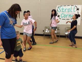MGC members teach dance steps to students in the stroll corner!