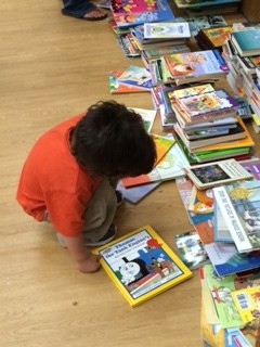 A student chooses his book from the book walk!