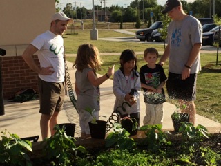 ​Week 8. The CASP staff and the Garden Your Own Growth team watch on as students water the garden and take responsibility for their food.